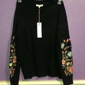 Black sweater with flowers on sleeve